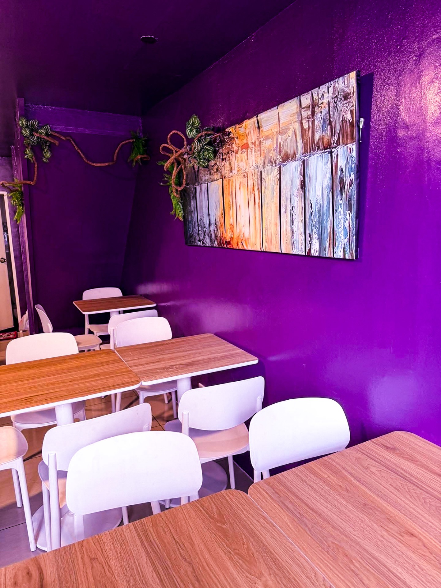 Cozy purple-walled seating area inside Brewhas